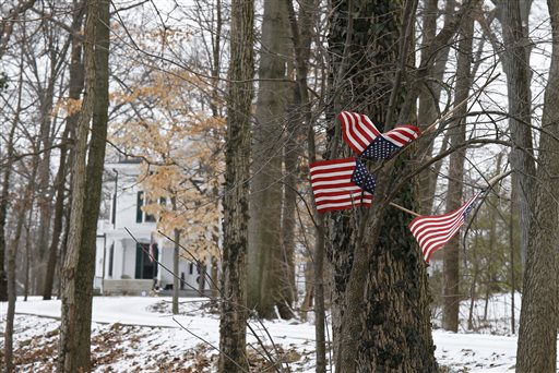 Small American flags have been placed in the trees in front of the Warmbier family home Friday Jan. 22 2016 in Wyoming Ohio. North Korea on Friday announced the arrest of Otto Warmbier a university student from Ohio for what it called a